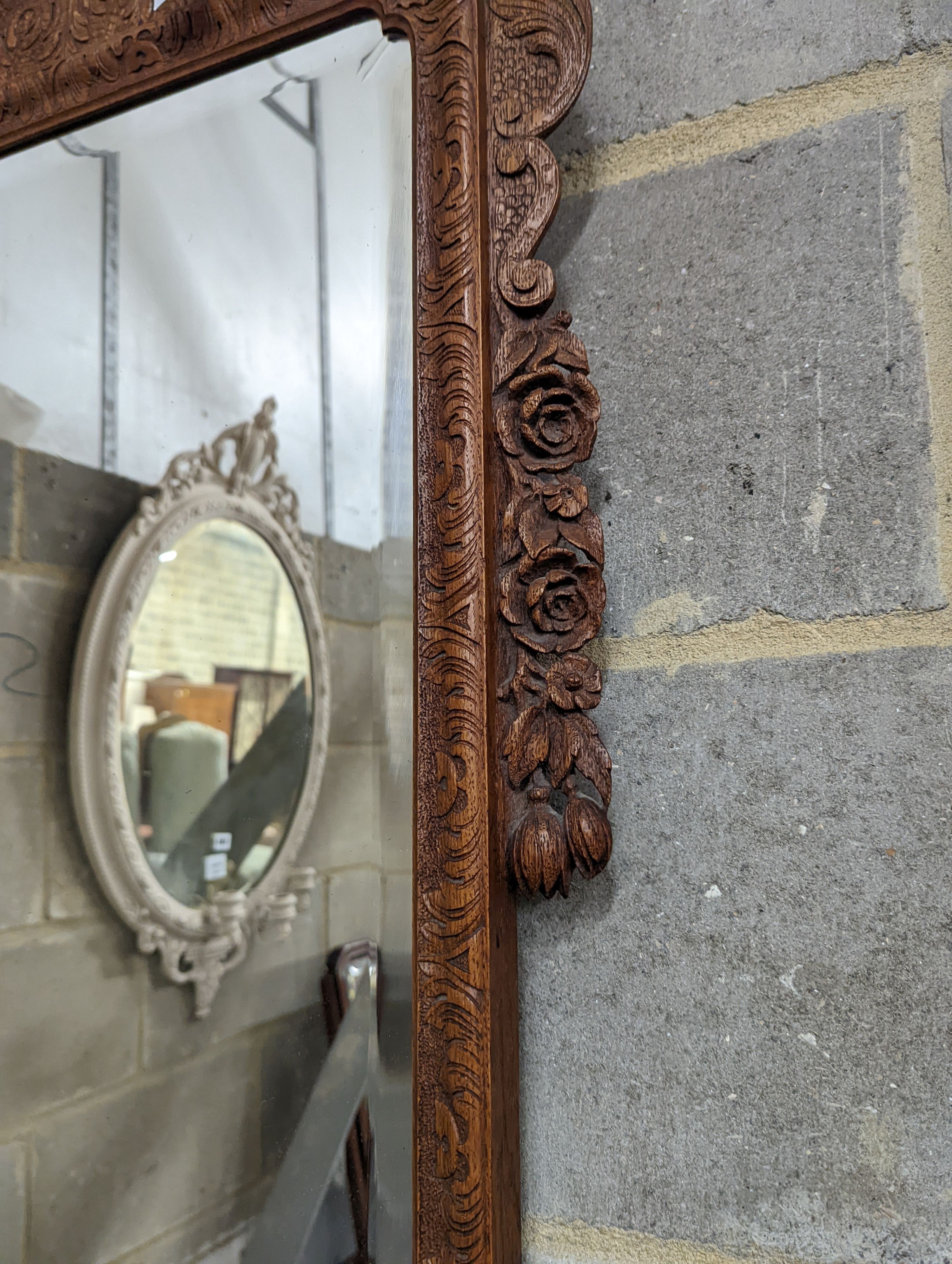 An 18th century style carved wood wall mirror, width 64cm, height 124cm